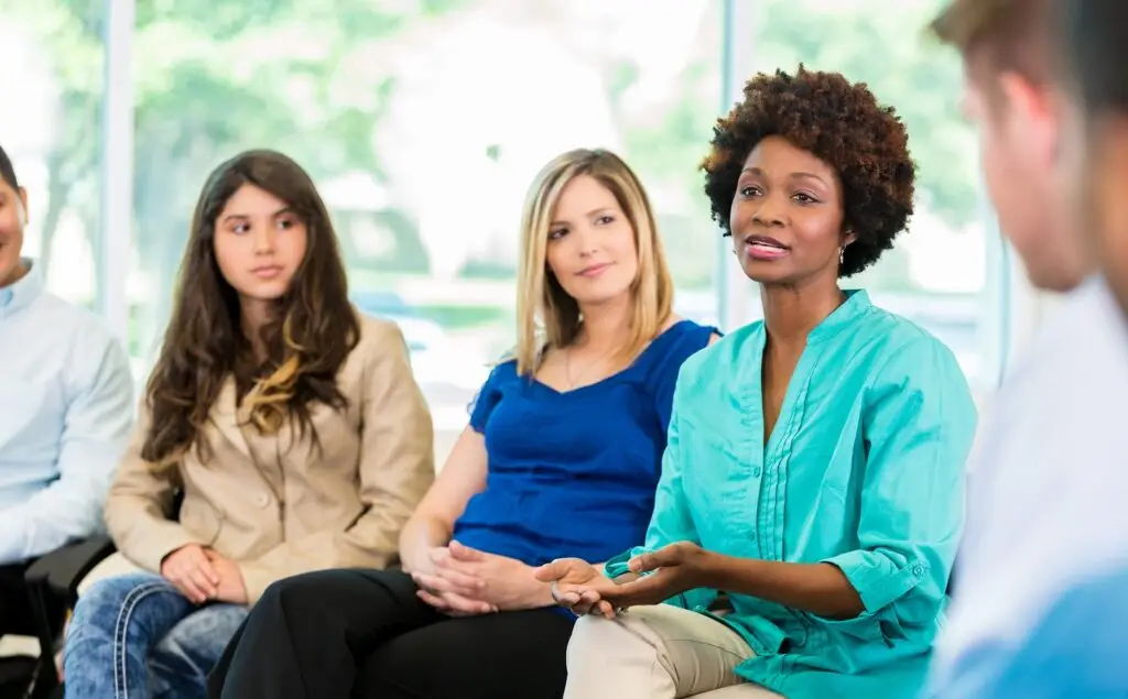 women's mental health issue speaking during group therapy