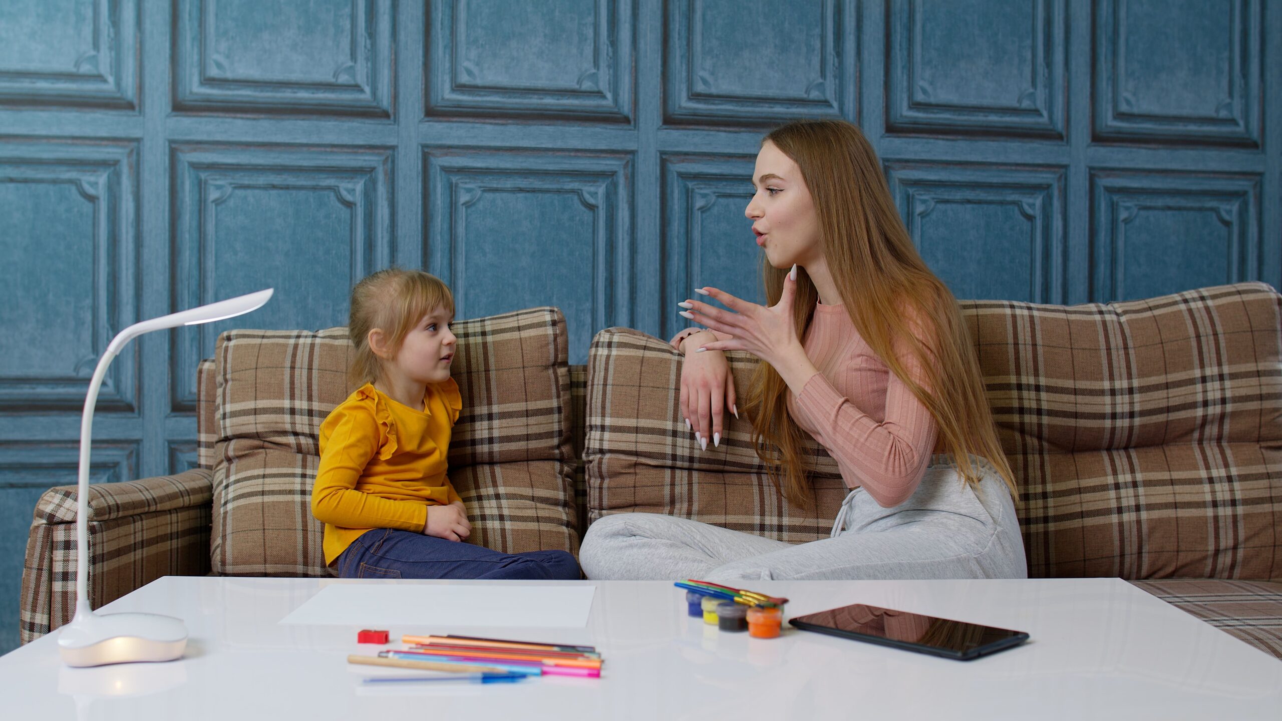 a woman and a child sitting on a couch